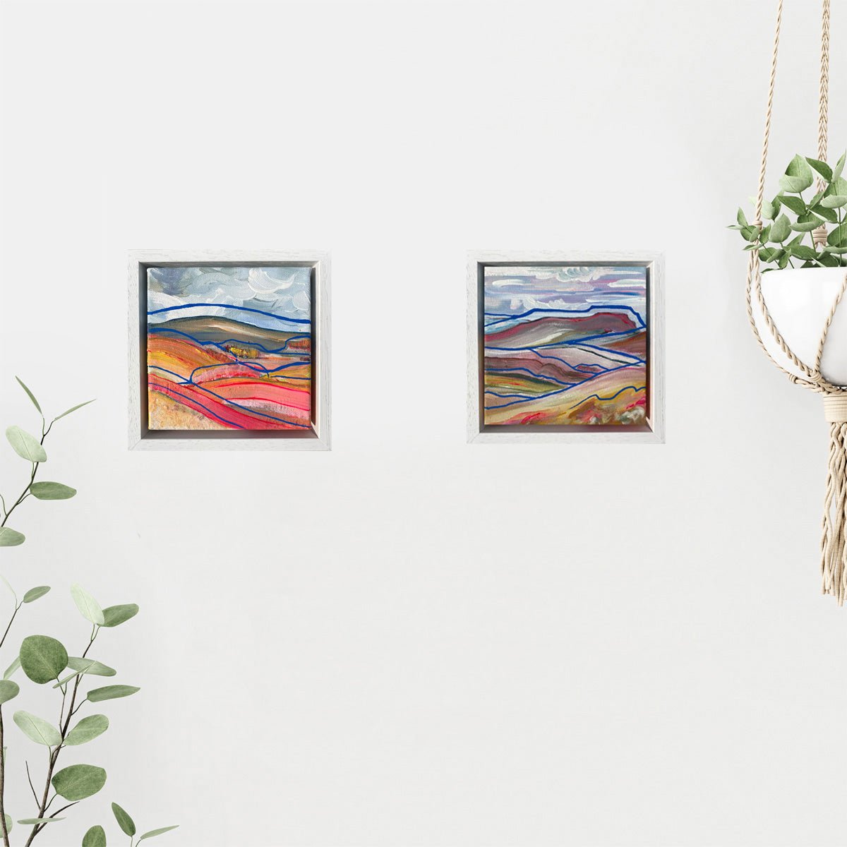 15 x 15cm abstract landscape painting inspired by the Yorkshire Dales National Park, featuring sweeping brushstrokes in yellow, pink, white, grey, and blue acrylic, framed in a 4cm deep painted wooden frame; expressive, free-flowing, and full of movement.