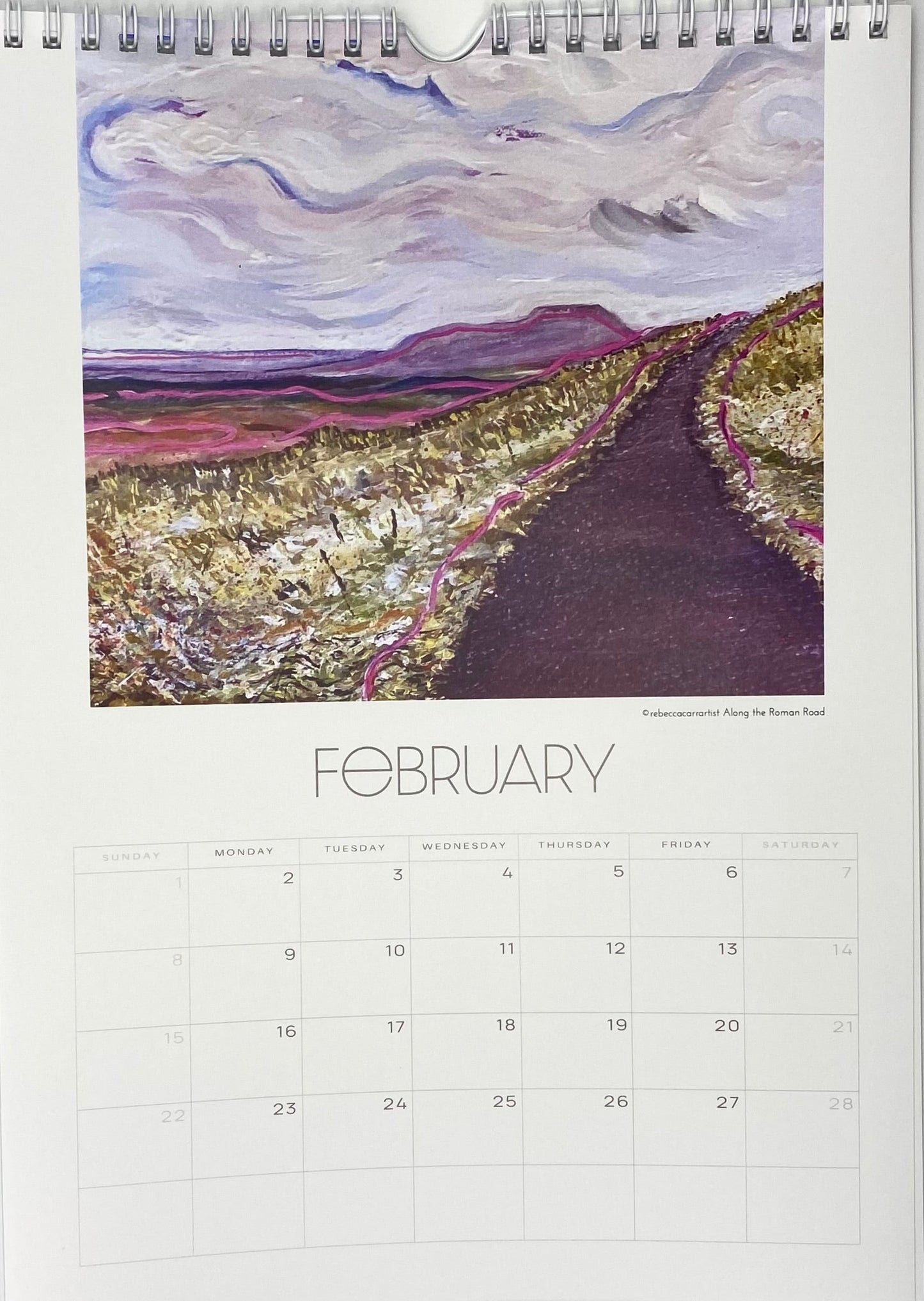 Calendar page for February with a painting of a road and mountains. hawes yorkshire dales