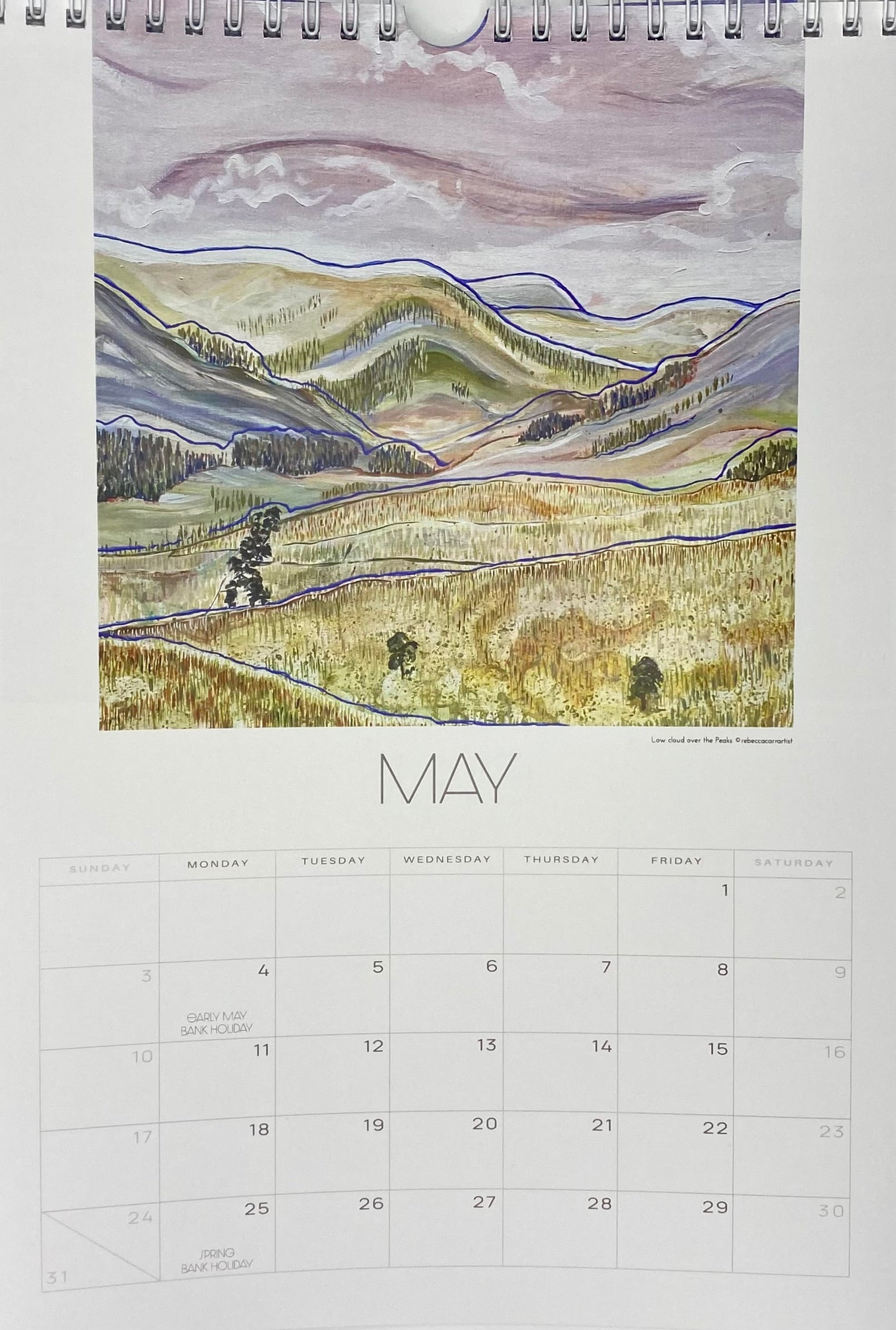 Calendar page for May with a landscape illustration on a white background