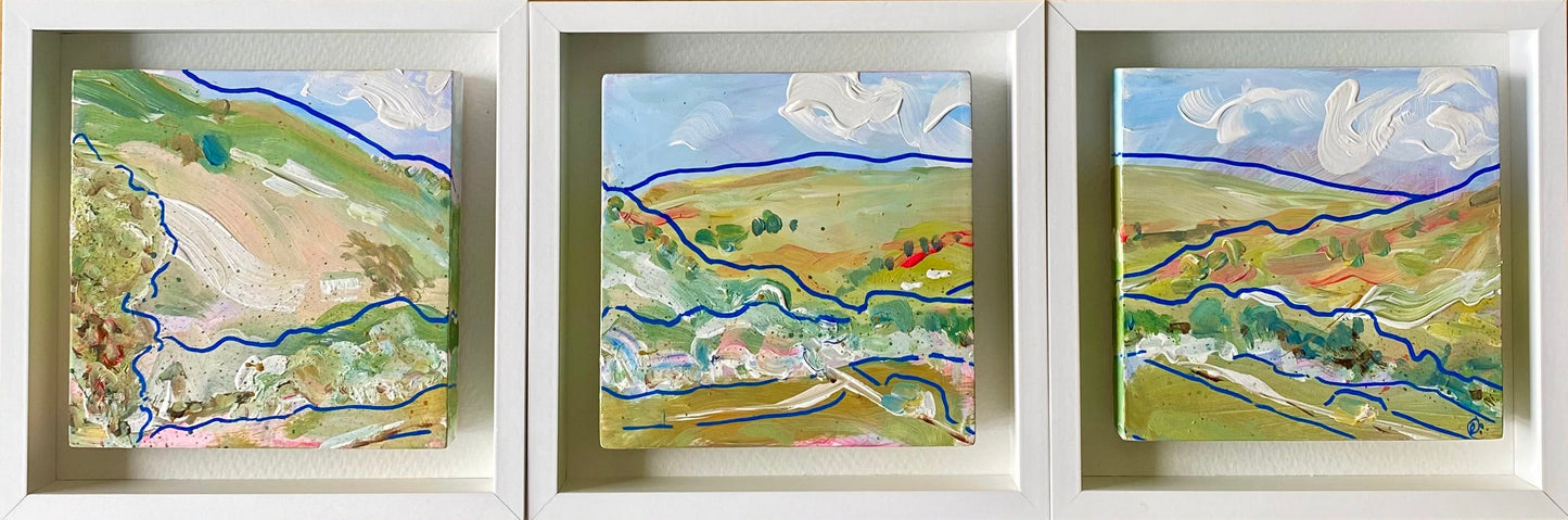 Mini abstract triptych painted with chalk paint and acrylic on a 12 x 12cm gesso block, featuring free-flowing blue lines and expressive strokes in white, green-blue, pink, and earth tones, mounted on watercolor paper and framed in a 15 x 15cm white wooden float frame.