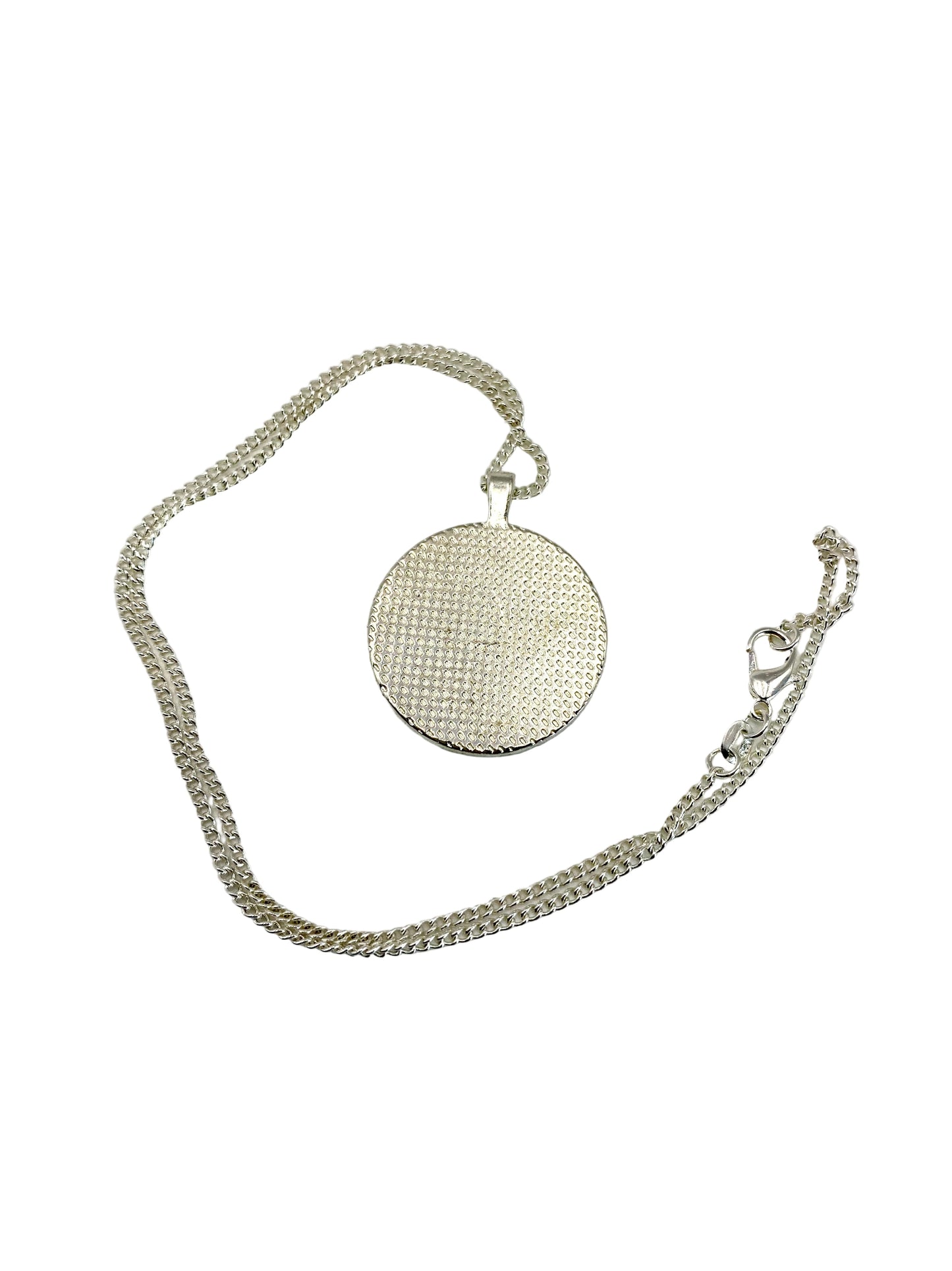 Silver necklace with a round textured pendant on a white background
