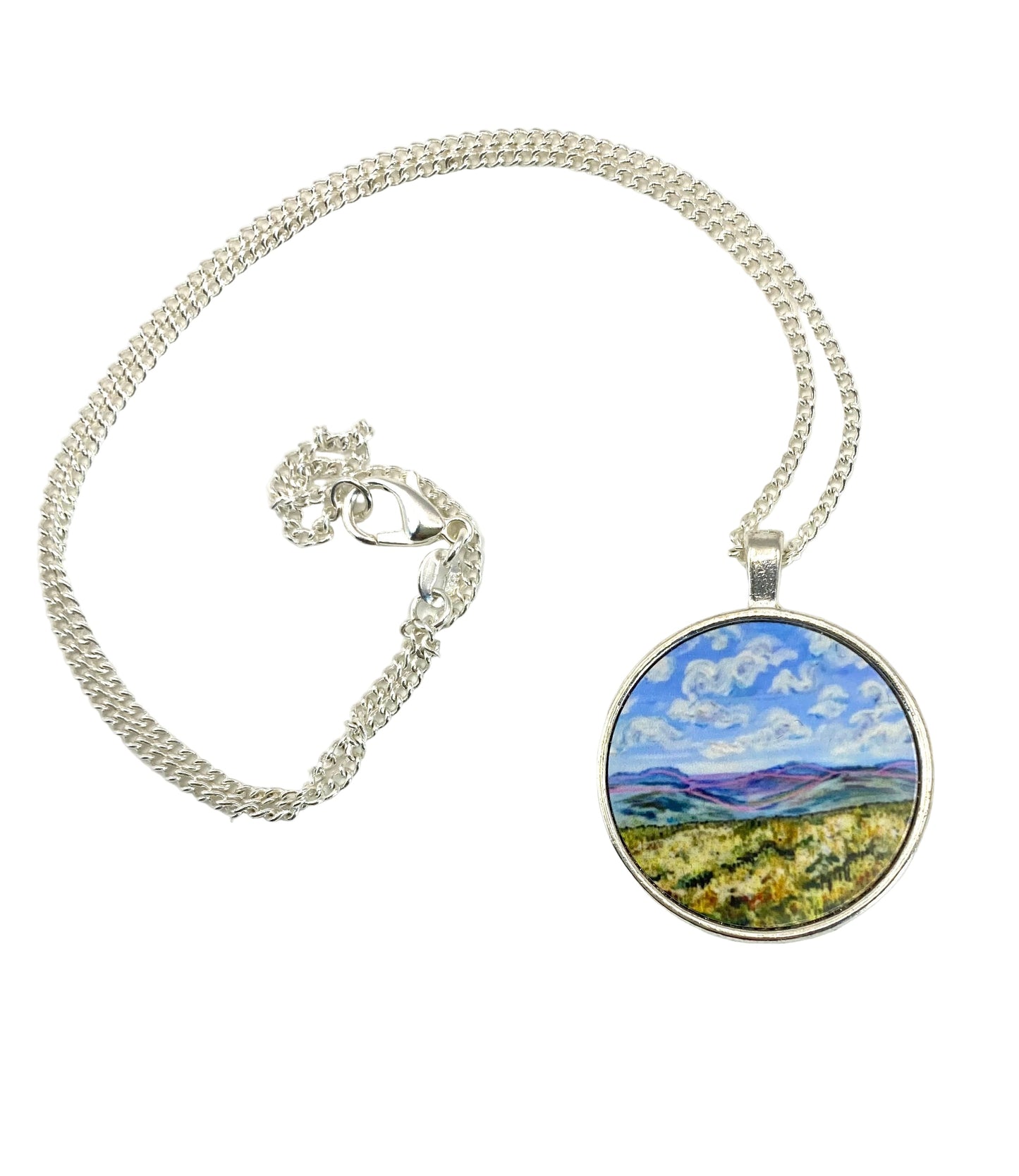 Necklace with a pendant featuring a landscape design on a white background