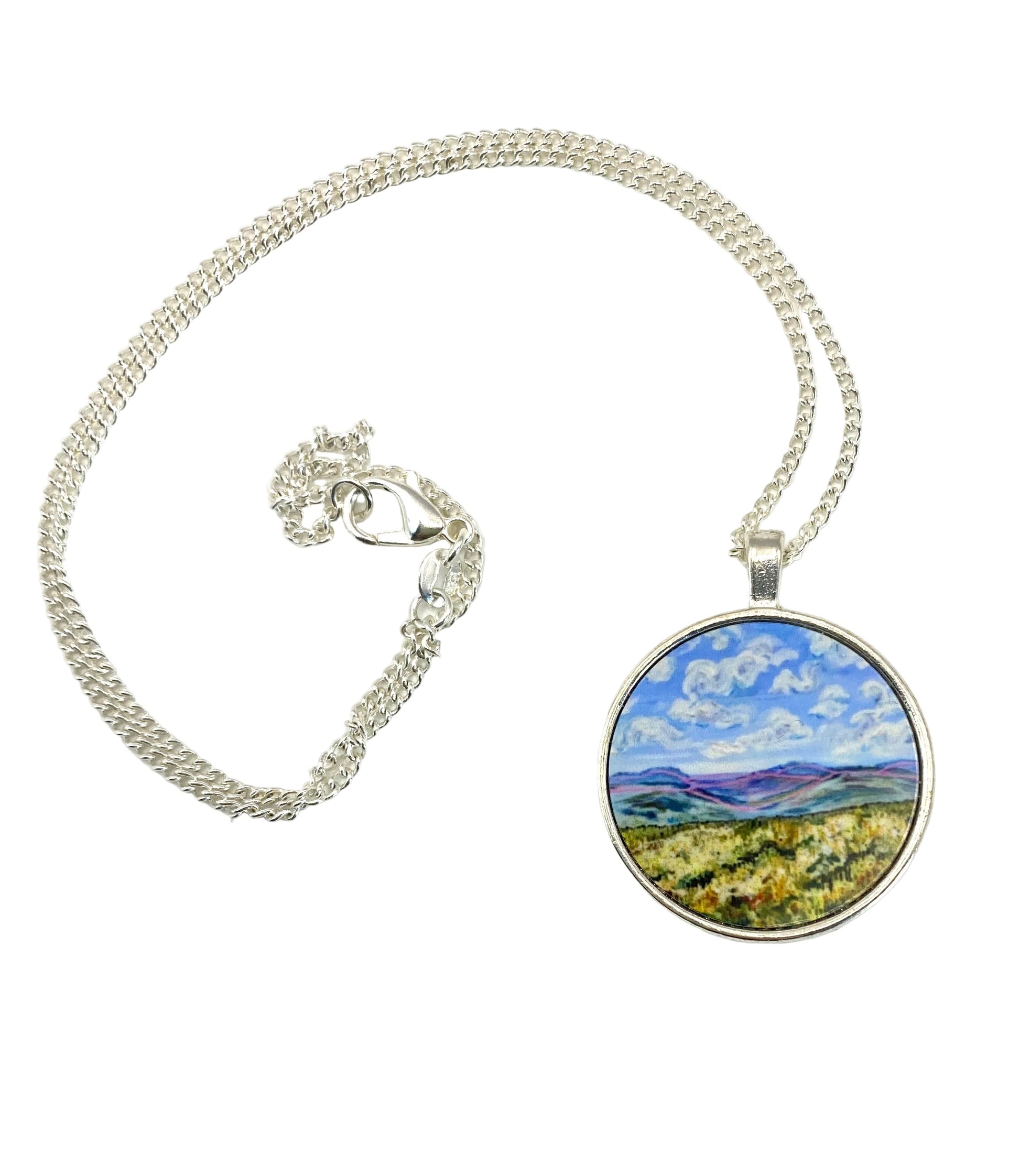 Necklace with a pendant featuring a landscape design on a white background
