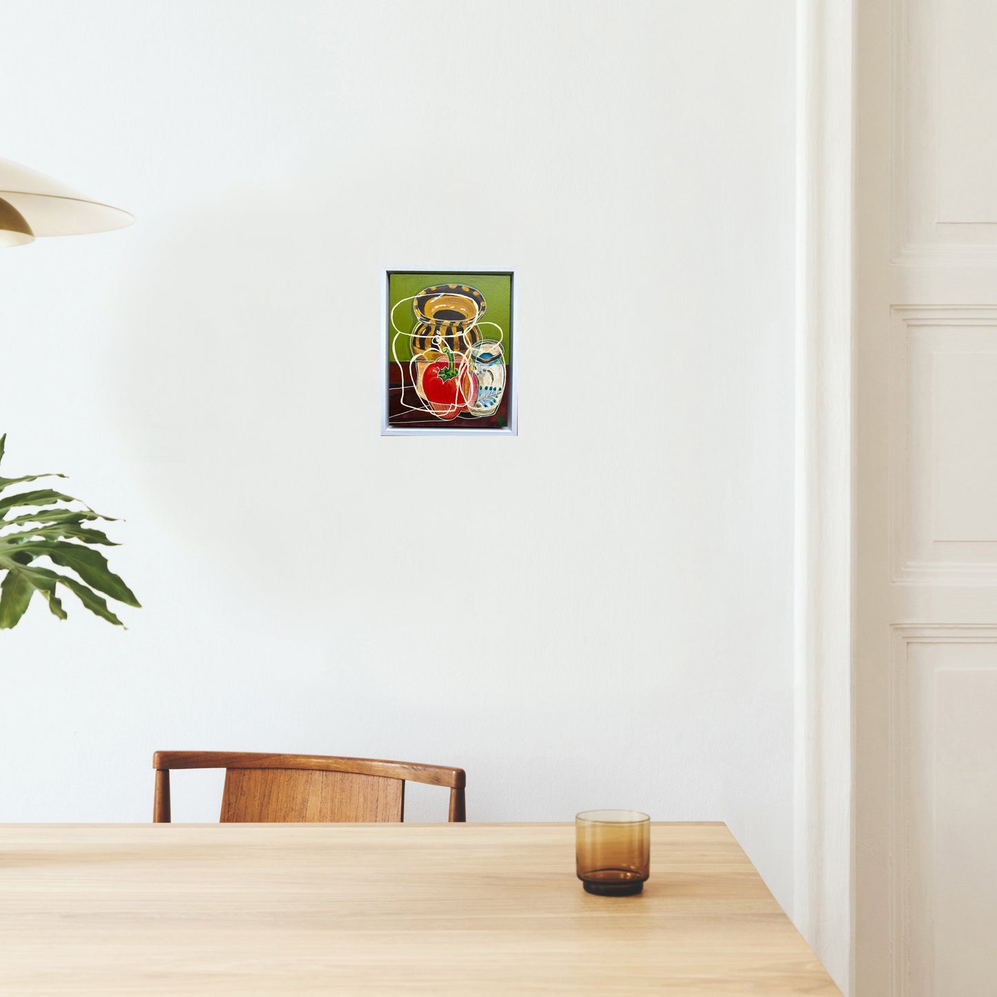 still life painting by rebecca carr mock up in living space painting on a white wall above a wooden table with a studio pottery