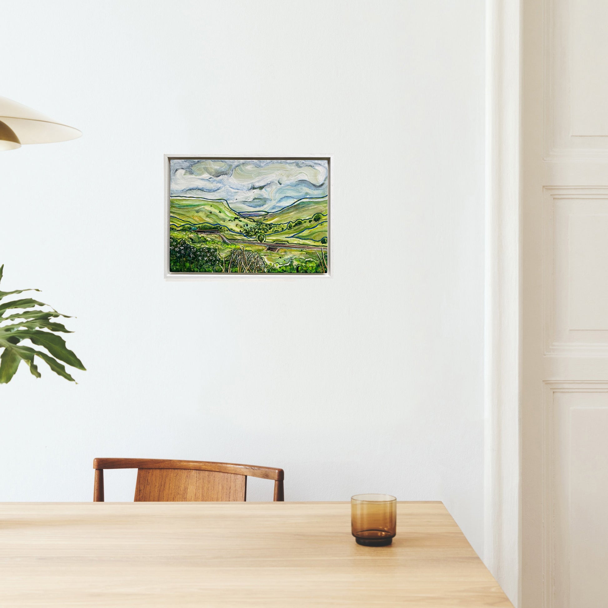 Framed original painting "On the Way to Appleby" showing Upper Eden Valley landscape with river Eden, sweeping clouds, green hills, railway track, birds in the sky, and a subtle horse and cart.